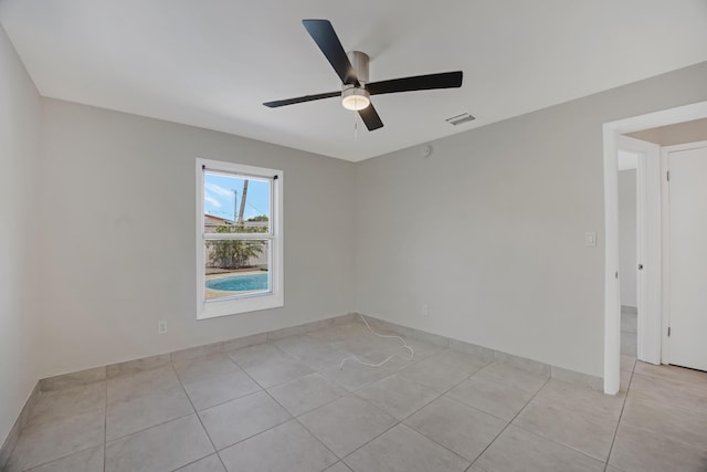unfurnished room featuring light tile patterned floors, ceiling fan, and visible vents