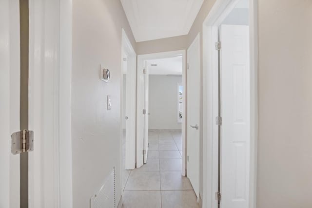 hall featuring light tile patterned floors and visible vents