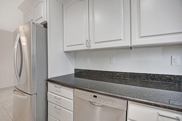 kitchen featuring white cabinets, dark stone countertops, and appliances with stainless steel finishes