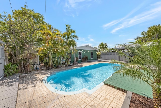 view of swimming pool featuring fence, a patio, and a fenced in pool