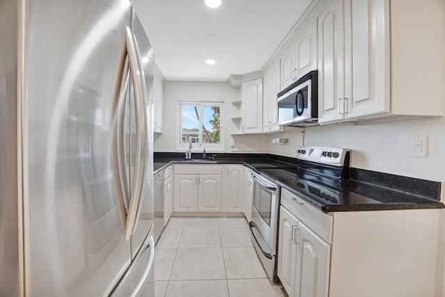 kitchen featuring a sink, open shelves, light tile patterned floors, white cabinets, and appliances with stainless steel finishes