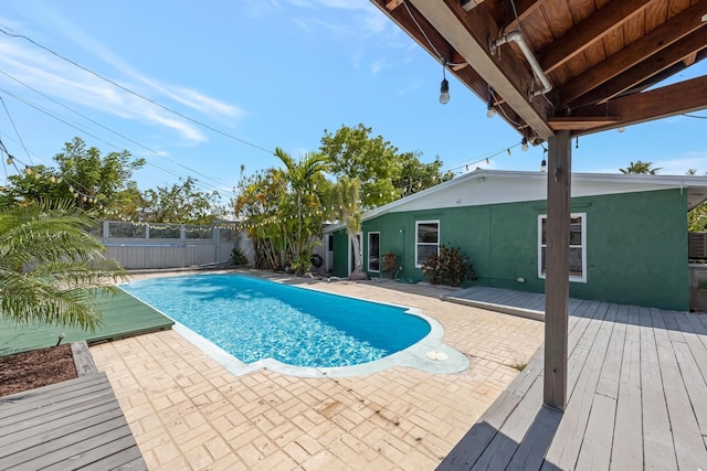 view of pool with a patio area, a fenced backyard, a wooden deck, and a fenced in pool