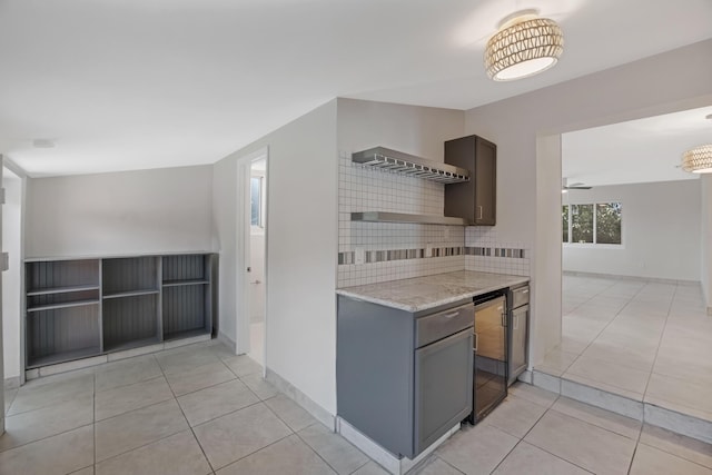 kitchen with wine cooler, baseboards, light tile patterned floors, and decorative backsplash