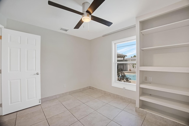unfurnished bedroom with light tile patterned floors, ceiling fan, baseboards, and visible vents