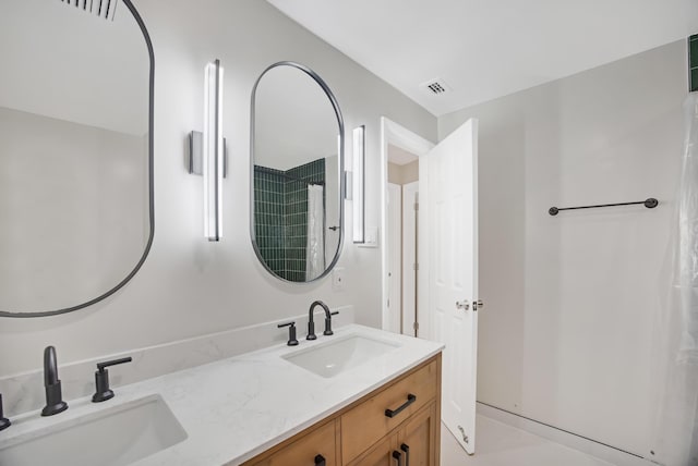 bathroom featuring a sink, double vanity, and visible vents