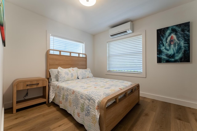 460 Barry Ave, Little Torch, FL 33042 - bedroom with an AC wall unit and wood finished floors