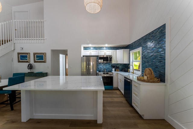 460 Barry Ave, Little Torch, FL 33042 - kitchen with stainless steel appliances, a high ceiling, a kitchen island, white cabinets, and dark wood-style flooring