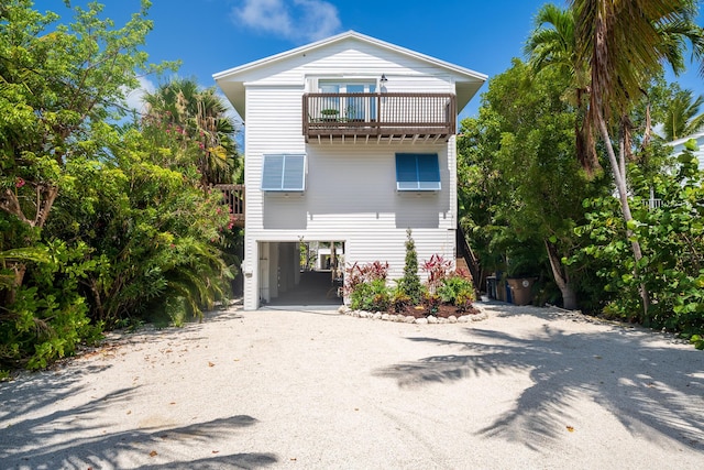 460 Barry Ave, Little Torch, FL 33042 - raised beach house featuring a carport, a balcony, and dirt driveway