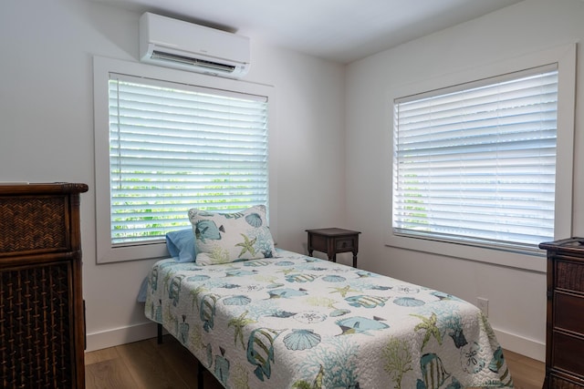 460 Barry Ave, Little Torch, FL 33042 - bedroom featuring a wall unit AC, wood finished floors, and multiple windows