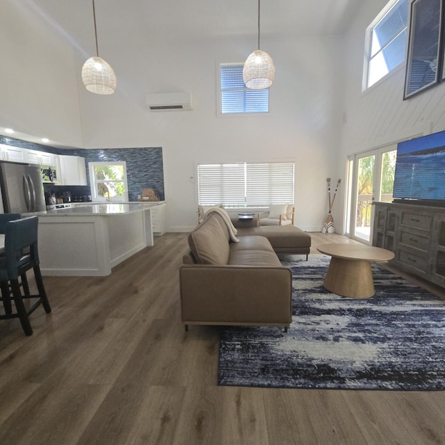 460 Barry Ave, Little Torch, FL 33042 - living area with a high ceiling, a wall unit AC, wood finished floors, and plenty of natural light
