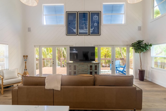 460 Barry Ave, Little Torch, FL 33042 - living room featuring french doors, wood finished floors, healthy amount of natural light, a high ceiling, and a decorative wall