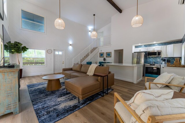460 Barry Ave, Little Torch, FL 33042 - living room with stairway, high vaulted ceiling, light wood finished floors, and beamed ceiling