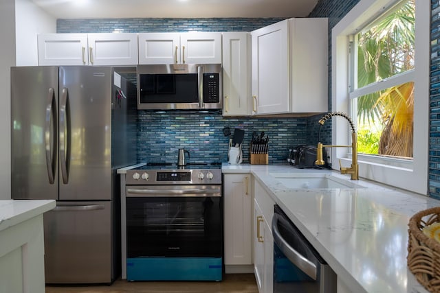 460 Barry Ave, Little Torch, FL 33042 - kitchen with stainless steel appliances, backsplash, white cabinets, and light stone countertops