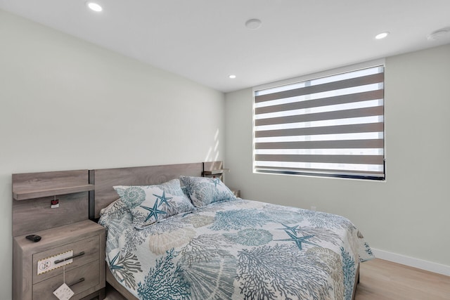 bedroom with recessed lighting, baseboards, and wood finished floors