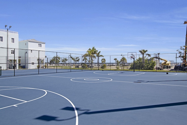 view of basketball court featuring fence and community basketball court