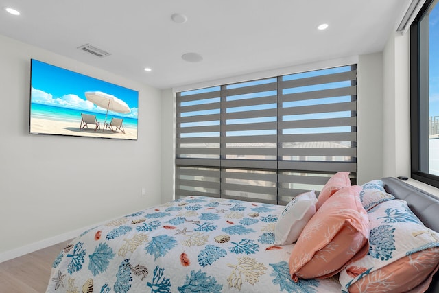 bedroom with visible vents, recessed lighting, baseboards, and wood finished floors