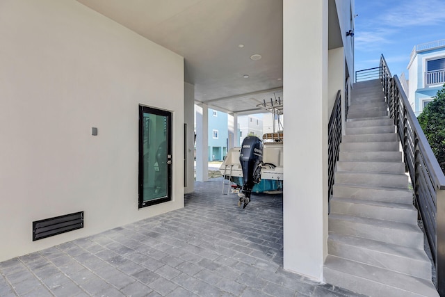 exterior space with visible vents and stairway