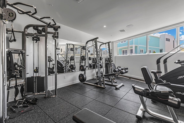 exercise room featuring baseboards and visible vents