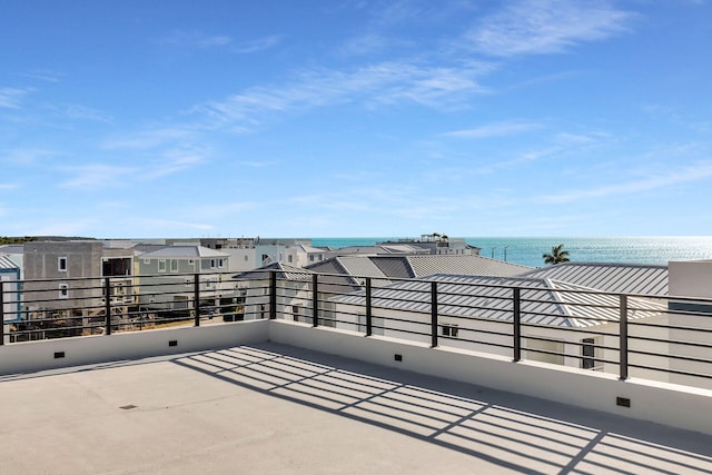 view of patio / terrace with a water view and a balcony