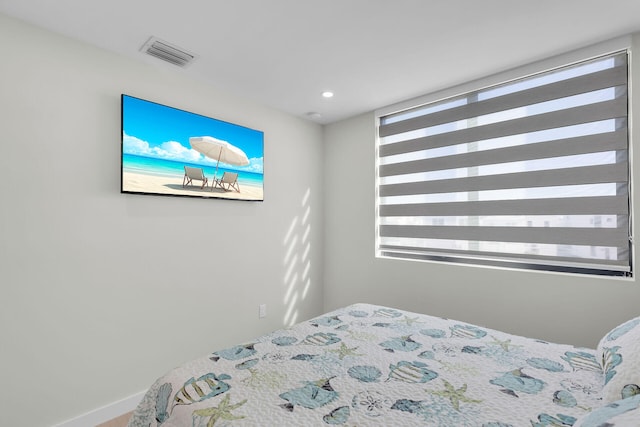 bedroom featuring visible vents and multiple windows