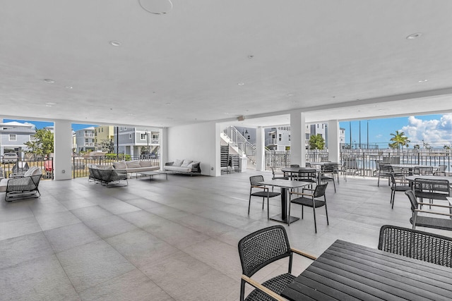 view of patio / terrace with stairway, fence, outdoor lounge area, and outdoor dining space