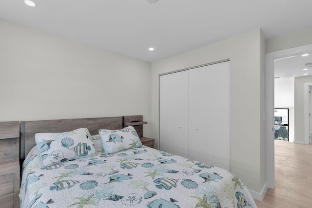 bedroom featuring a closet and light wood-type flooring