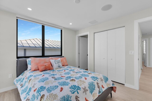 bedroom featuring a closet and light hardwood / wood-style flooring