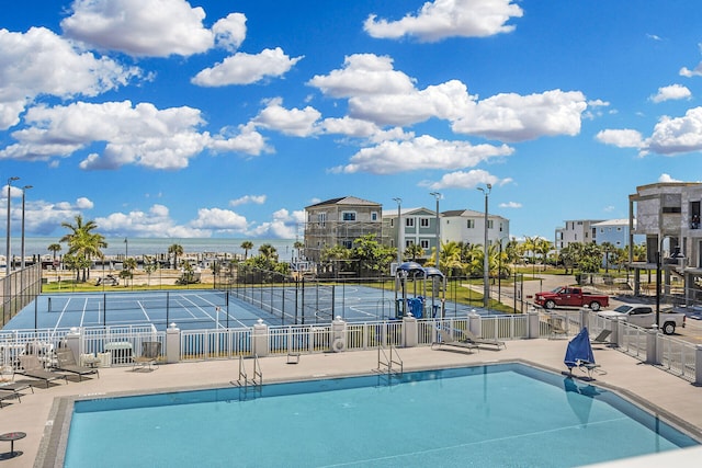 community pool featuring fence and a patio area