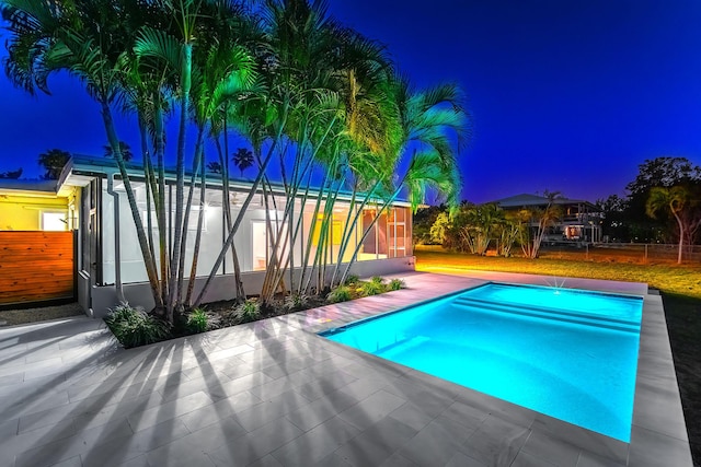 pool at twilight with a patio