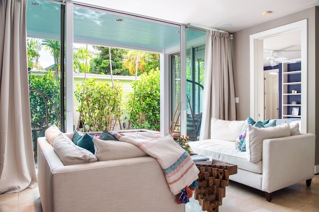 living room featuring floor to ceiling windows, light tile patterned floors, and ceiling fan