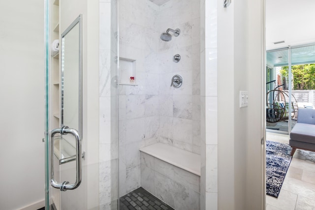 bathroom featuring a shower with door