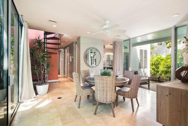 dining space with light tile patterned floors, expansive windows, and ceiling fan