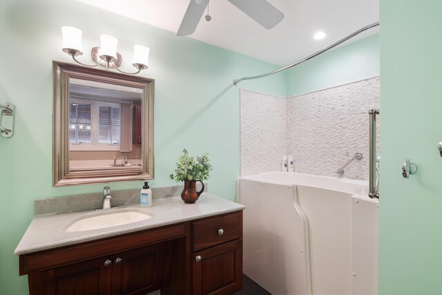 bathroom featuring vanity, a bathtub, and ceiling fan