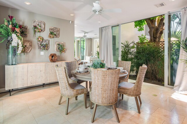 dining room featuring a wall of windows and light tile patterned floors