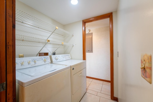 laundry room with washer and clothes dryer and light tile patterned flooring