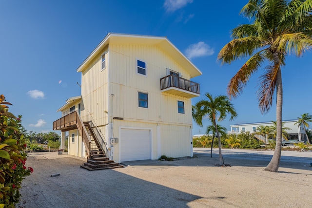 exterior space featuring a garage and a balcony