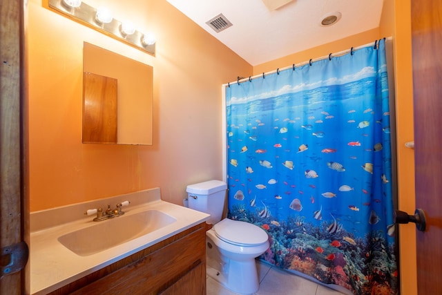 bathroom featuring vanity, a shower with shower curtain, tile patterned floors, and toilet