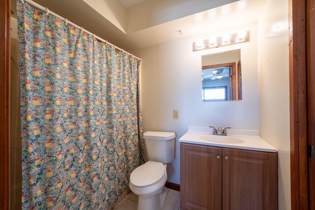 bathroom with a shower with shower curtain, vanity, toilet, and tile patterned flooring