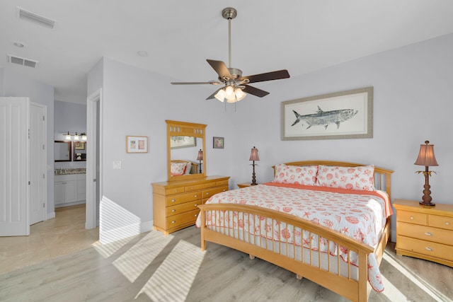 23 S Kyle Way, Marathon, FL 33050 - bedroom with ceiling fan, ensuite bathroom, and light hardwood / wood-style flooring
