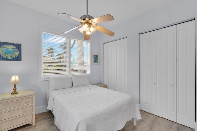 23 S Kyle Way, Marathon, FL 33050 - bedroom featuring multiple closets, ceiling fan, and light hardwood / wood-style flooring