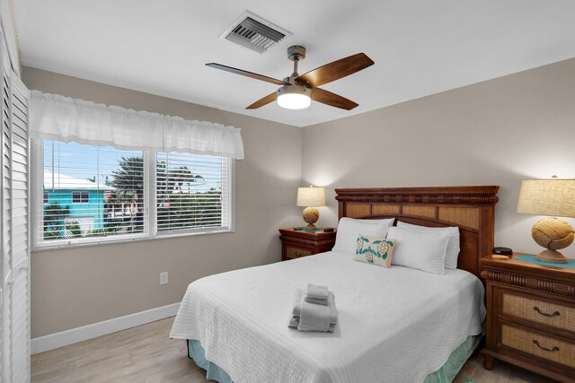 bedroom with ceiling fan and light hardwood / wood-style floors