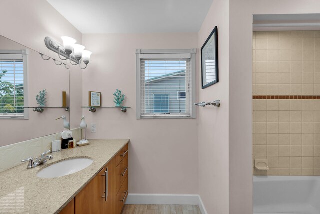 bathroom with vanity and tiled shower / bath combo