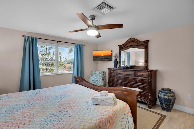 bedroom with light hardwood / wood-style floors and ceiling fan