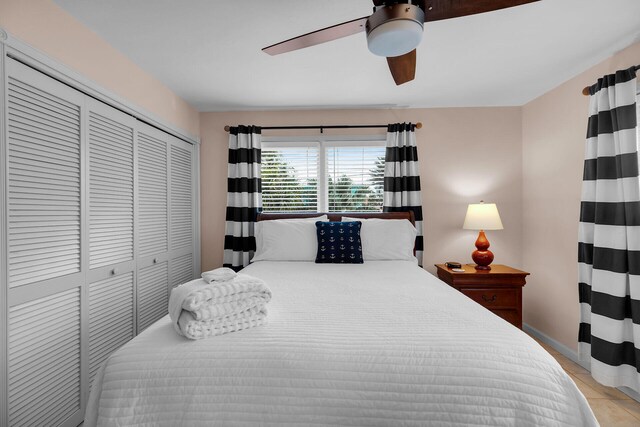 tiled bedroom with a closet and ceiling fan