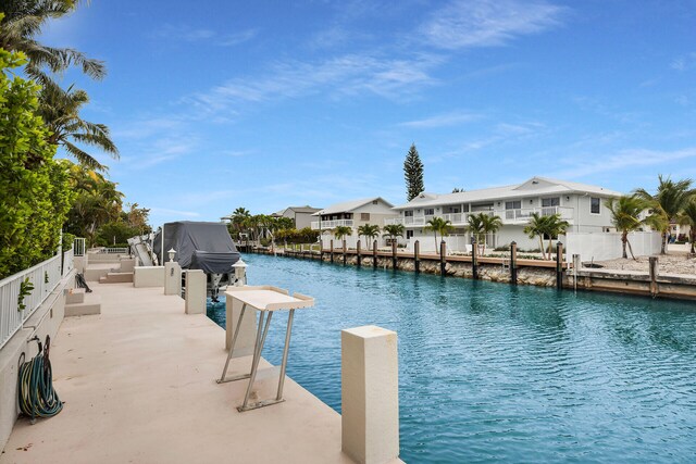 exterior space featuring a dock and a water view