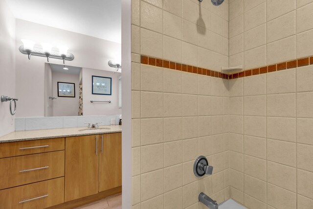 bathroom featuring vanity and tiled shower / bath combo