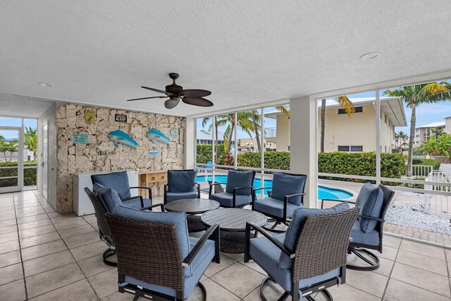 view of patio with an outdoor living space and ceiling fan