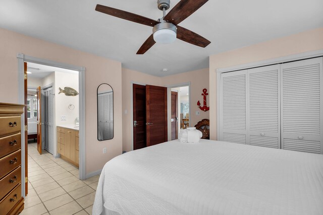 tiled bedroom featuring connected bathroom, a closet, and ceiling fan