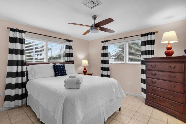 tiled bedroom featuring ceiling fan