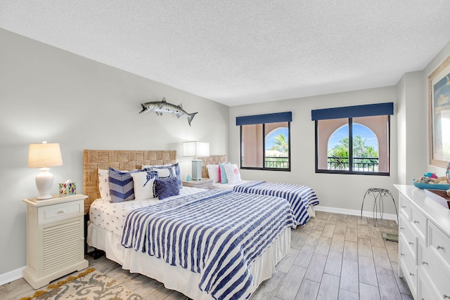 bedroom featuring a textured ceiling and light hardwood / wood-style floors